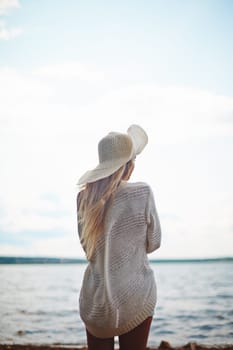 Rear view of female spending vacation by the sea