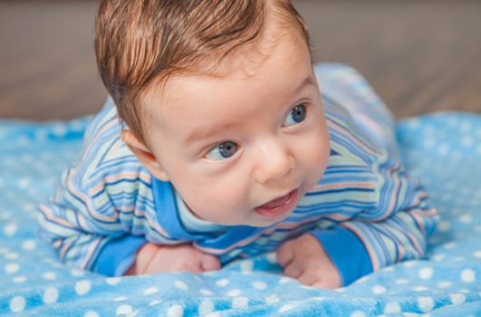 Portrait of a 2 months old baby boy at his home.