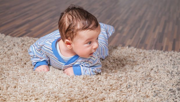 Portrait of a 2 months old baby boy at his home.