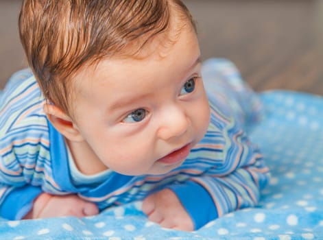 Portrait of a 2 months old baby boy at his home.
