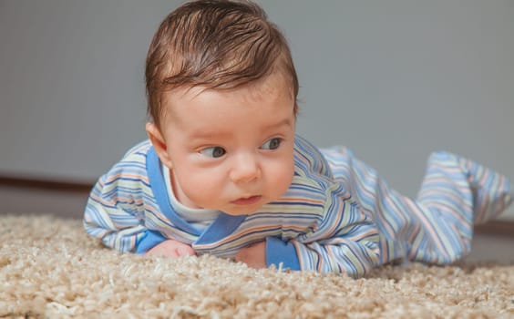 Portrait of a 2 months old baby boy at his home.
