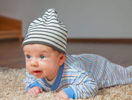 Portrait of a 2 months old baby boy at his home.