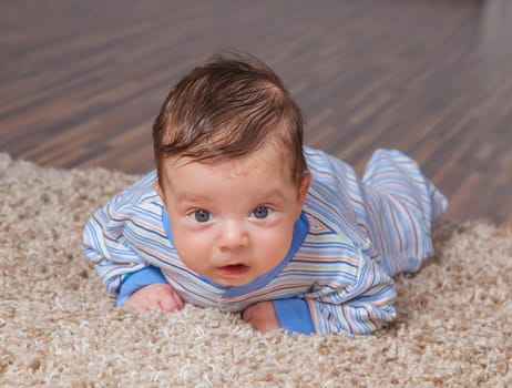 Portrait of a 2 months old baby boy at his home.