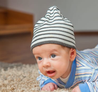 Portrait of a 2 months old baby boy at his home.