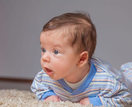 Portrait of a 2 months old baby boy at his home.