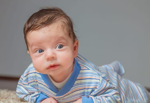 Portrait of a 2 months old baby boy at his home.