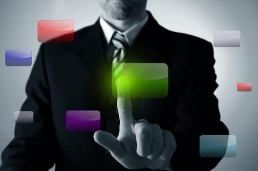 Business man pushing a green button on a touchscreen