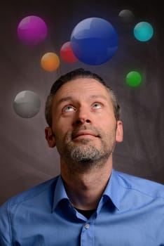 Business man looking up to colorful glass buttons