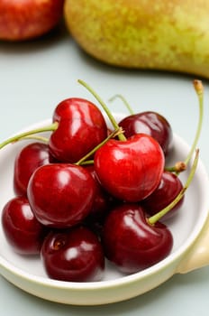 Sweet cherries in a bowl on a kitchen table