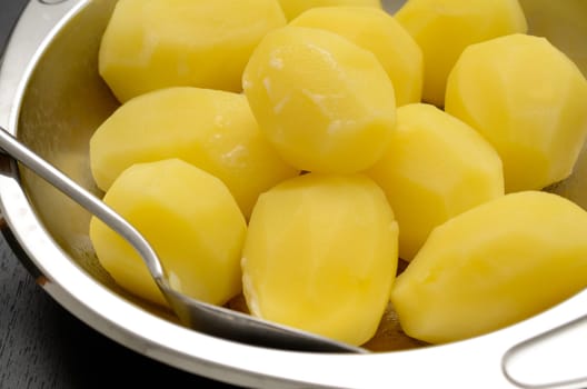 Boiled potatoes in a steel bowl