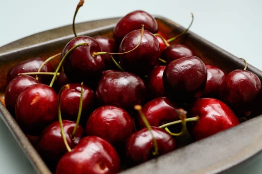 Close up of fresh cherries in a ceramic bowl
