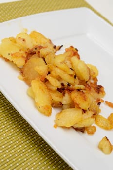 Roasted potatoes on a white plate