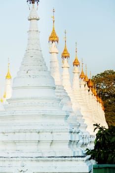 Kuthodaw Pagoda is a Buddhist stupa, located in Mandalay, Burma (Myanmar), that contains the world's largest book. It lies at the foot of Mandalay Hill. In the grounds of the pagoda are 729 stone-inscription caves, each containing a marble slab inscribed on both sides with a page of text from the Tipitaka, the entire Pali Canon of Theravada Buddhism. Pagoda Kuthodaw stretching from 1860 to 1868 during the reign of King Mindona.