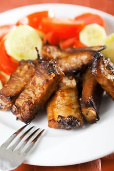 Baked pork ribs with salad