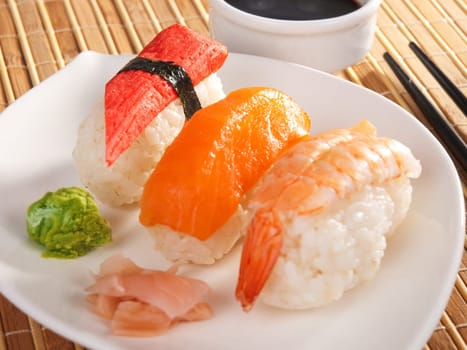 Three types of nigiri sushi - with salmon, shrimp and surimi