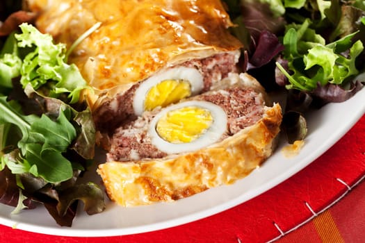 Meatloaf with boiled eggs in puff pastry