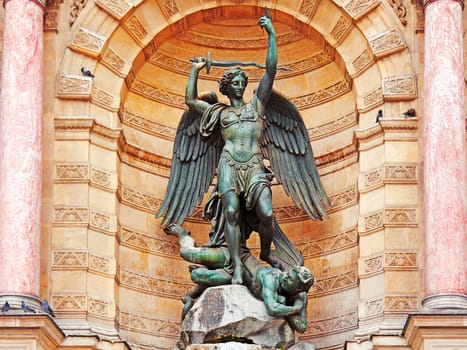 The statue of Saint Michael atop the fountain in the Place Saint-Michel at the northern end of the Boulevard Saint-Michel