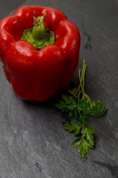 Red paprika on a dark slate board