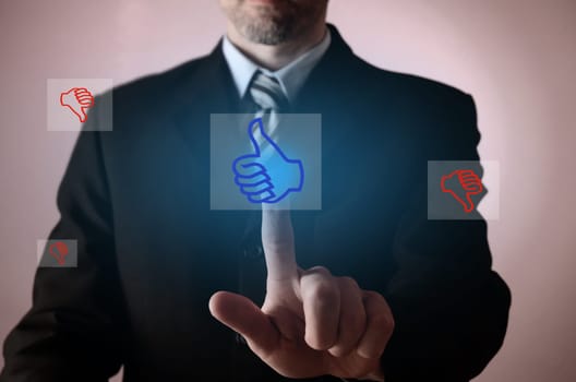 Business man pointing on a thumb up icon, positive business concept