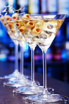 Several glasses of famous cocktail Martini, shot at a bar with shallow depth of field..Ingredients