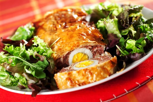 Meatloaf with boiled eggs in puff pastry