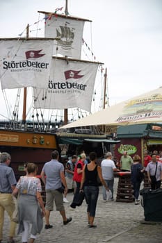 Mainz,Germany – July 11,2015: Passers-by and visitors to the summer festival Mainzer Bierbörse pass the stall of the Störtebeker Brauspezialitäten Brewery on July 11,2015 in Mainz.