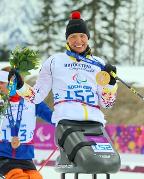 The winning smile is back: Andrea ESKAU holds the GOLDMEDAILLE after the cross-country race over five kilometers Cross Country Skianglauf - 9th day of competition Paralympics Sochi 2014 / Paralympic Winter Games Sochi 2014