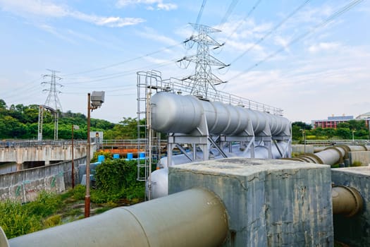 Glow light of petrochemical industry water tank on sunset