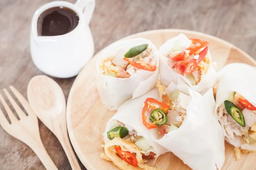 Fresh spring rolls on wooden table, stock photo