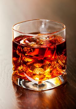 Whisky on the rocks on a table. Very shallow depth of field.
