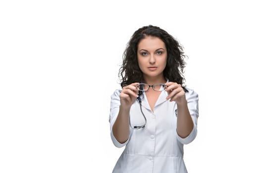 Optician or oculist woman giving a pair of glasses on white background.