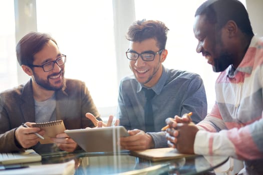 Three businessmen discussing new project at meeting