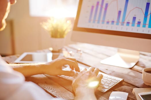 Male employee or manager typing at workplace