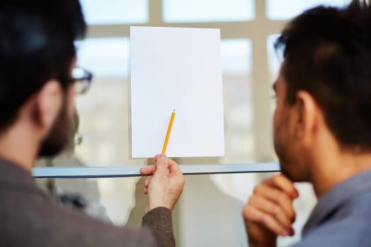 Businessman pointing at blank paper at meeting