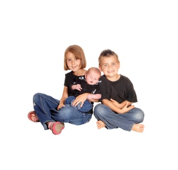 A young girl and her brother sitting on the floor isolated for white.background, holding there three weeks old baby..