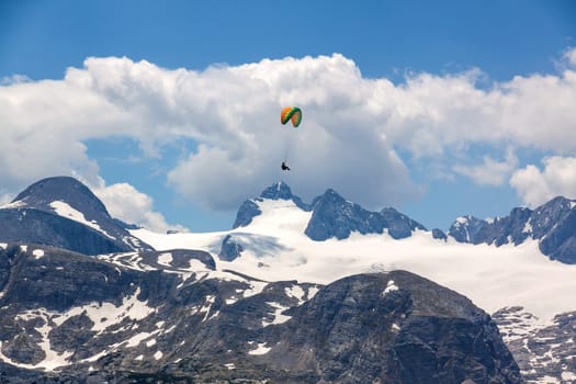 Paraglider at the sky over the Dachstein mountains