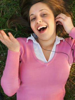 Woman listening to music on the grass