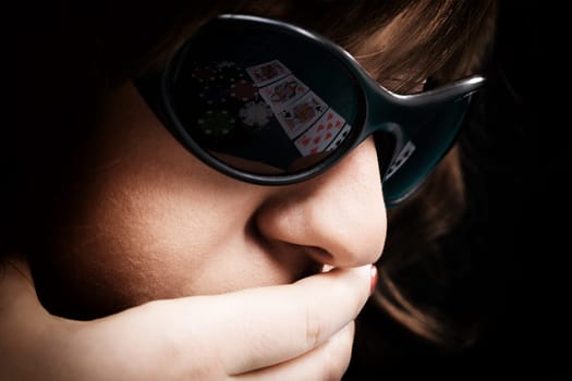 Young woman with black sunglasses reflecting cards