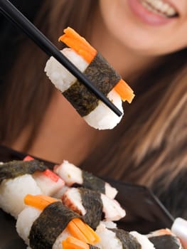 Girl eating sushi, close up