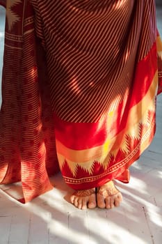 Indian picture on woman feet, mehendi tradition decoration, resistant design by special paint, brown henna.  Indian red dress on white background
