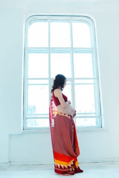 Indian picture on woman hands and pregnant belly with henna tattoo  on white room background
