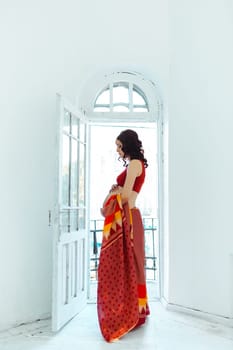 Indian picture on woman hands and pregnant belly with henna tattoo  on white room background