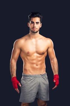 Handsome and sexy muscular man, isolated over gray background