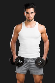 Portrait of a young male Body Combat atlhlete, jumping and kicking