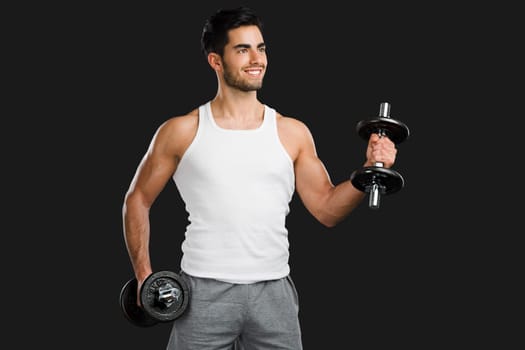 Portrait of a young male Body Combat atlhlete, jumping and kicking