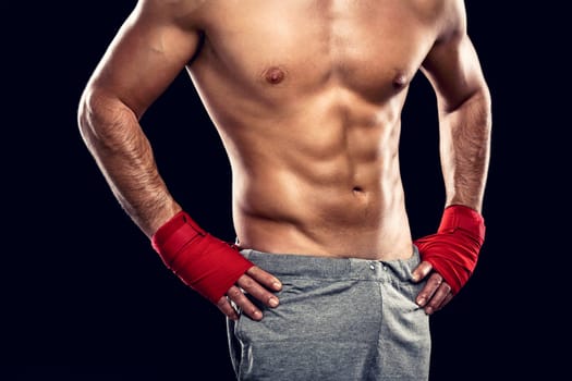 Handsome and sexy muscular man, isolated over gray background