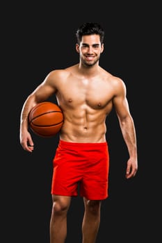 Handsome and sexy muscular man, isolated over gray background