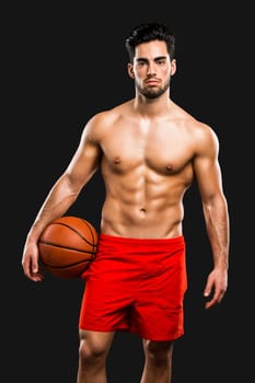 Handsome and sexy muscular man, isolated over gray background