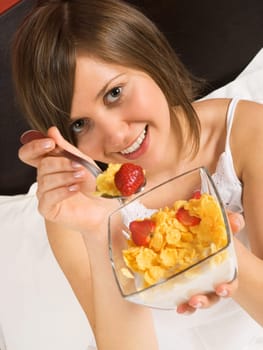 Woman in bed heaving breakfast