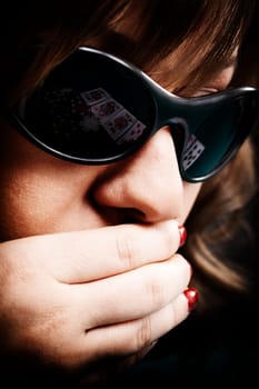 Young woman with black sunglasses reflecting cards
